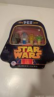 Front view of original Star Wars-shaped tin packaging containing four limited edition PEZ dispensers and candy, labelled 'Limited PEZ Edition'.