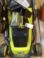Overhead view of mower body with battery and charger attached