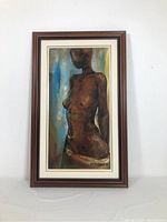 Full view of the framed painting showing the entire artwork in the wooden frame against the wall.