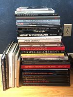 Stack of photography and art books showing titles on spines, includes history and notable photographers