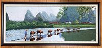 Full view of the framed silk embroidery landscape showing the river, person, water buffalo, and mountains.