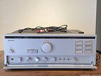 Front view of amplifier showing all controls, faceplate and RCA cables on top