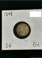 Photo of the reverse side of the 1898 Canadian 5 cent coin showing the denomination and some toning in the coin surface.