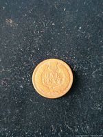 Reverse side of the 1904 Indian Head penny showing denomination and shield.