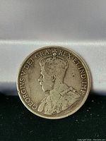 Obverse side of the 1916 Canadian 50 cent coin showing King George V and inscriptions.