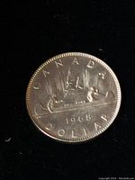 Reverse side showing voyageur and Indigenous person in canoe, date 1968 and inscriptions