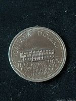 Reverse side of 1973 Canada Silver Dollar showing Prince Edward Island legislature building and commemorative text.