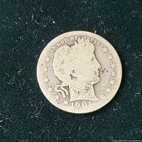 Obverse side of the 1901 Barber silver quarter showing Liberty head with date and stars.