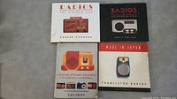 Four books laid out on a floor surface, showing varied cover designs featuring vintage radios.