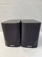 Front view of both Mission speakers side by side with cloth covers installed.