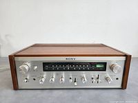 Front view showing aluminum faceplate, tuning display, knobs and sliders