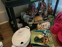 White ceramic lidded soup tureen with embossed floral design and side handles.