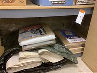 Photo showing multiple padded dish packing kits and customized glass storage boxes placed on floor and shelf.