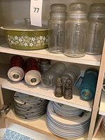 Top shelf with baking dish and three large clear Planters glass jars