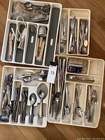 Full view of trays containing assorted flatware and kitchen gadgets