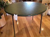 Full top view of the round green folding table