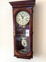 Front view of the entire wall clock in wood case.