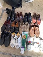 Lot of various men's shoes including boots, dress shoes, casual shoes, insoles and socks