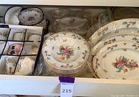 Full set of Noritake china showing plates, teacups, saucers, and other pieces inside a box.