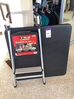 Two aluminum step stools by Gorilla Ladders stacked together, showing brand label and product details.