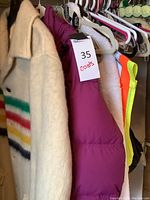 Overview of all five items: cream wool coat, pink puffer coat, white robe, quilted tote, safety vest