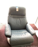 Front view of blue leather recliner chair showing high back and seat cushion