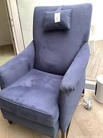 Front three-quarter view of the blue ultrasuede chair with lumbar pillow on seat
