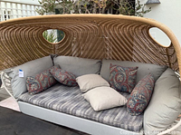 Front view of patio sofa showing seat cushion and throw pillows