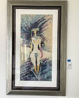 Full view of framed lithograph leaning against a wall