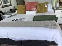 Front view of assembled adjustable bed with bedding and cushions