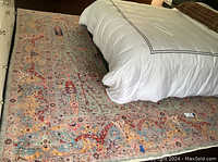 Full room view of rug under bed showing overall size and pattern
