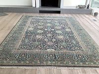 Full view of the rug laid flat on hardwood floor showing overall pattern and colors