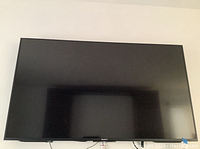 Front view of Sony TV powered off, black bezel with Sony logo