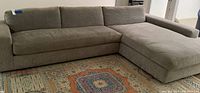 Front-left view of full L-shaped sectional on area rug