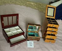 Photo showing all three wooden jewelry boxes side by side displaying different designs and compartments