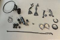 Full lot showing all jewelry pieces on a beige background.