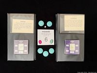 Photo showing labeled display cases of topaz and citrine stones and round turquoise-colored stones arranged around auction card