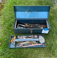 Open blue metal toolbox showing various hand tools inside and drawer pulled out with more tools sorted