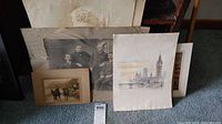 Photo showing a group black and white photo of men in suits, large faded portrait, and a colored print of Big Ben with London skyline.