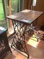Full view of the table showing wrought iron base and tile top