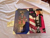 Two Barbie dolls in original packaging, labeled as USA Soldier Collection, placed on a white fabric background with a lot number card seen.