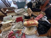 Overview of 18 assorted vintage and modern purses in various styles and materials laid on a flat surface