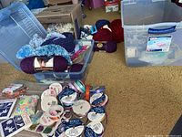 Wide view of the crafting supplies including yarn, ribbons, and plastic storage bins