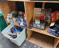 Three shelves holding various household tools, sanding materials and hardware items. Shows plastic bin with tools and organized drawers.