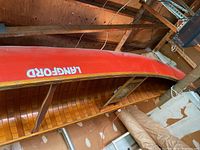 Interior view of canoe showing wooden rib construction and one mesh seat