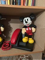 Mickey Mouse telephone shown from a slightly angled front view displaying the handset and figure