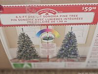 Close up photo of tree box showing brand Holiday Time and key features such as 6.5 ft height, pre-lit Sonoma Pine, color changing LED lights.