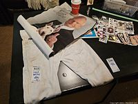 Don Cherry poster, white football pants, trading cards spread on a table