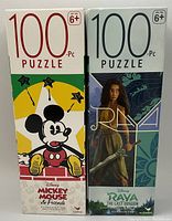 Two puzzle boxes side by side. Left box shows Disney Mickey Mouse & Friends artwork with 100 piece count marked. Right box shows Disney Raya and The Last Dragon artwork, also 100 pieces.