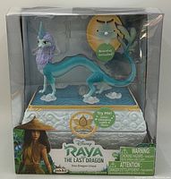 Front view of boxed Disney Raya and the Last Dragon Sisu Dragon Chest toy set featuring dragon figure on top and bracelet inside.